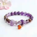 Nine purple fire amethyst and red agate Mori-style crystal bracelet on a wrist.