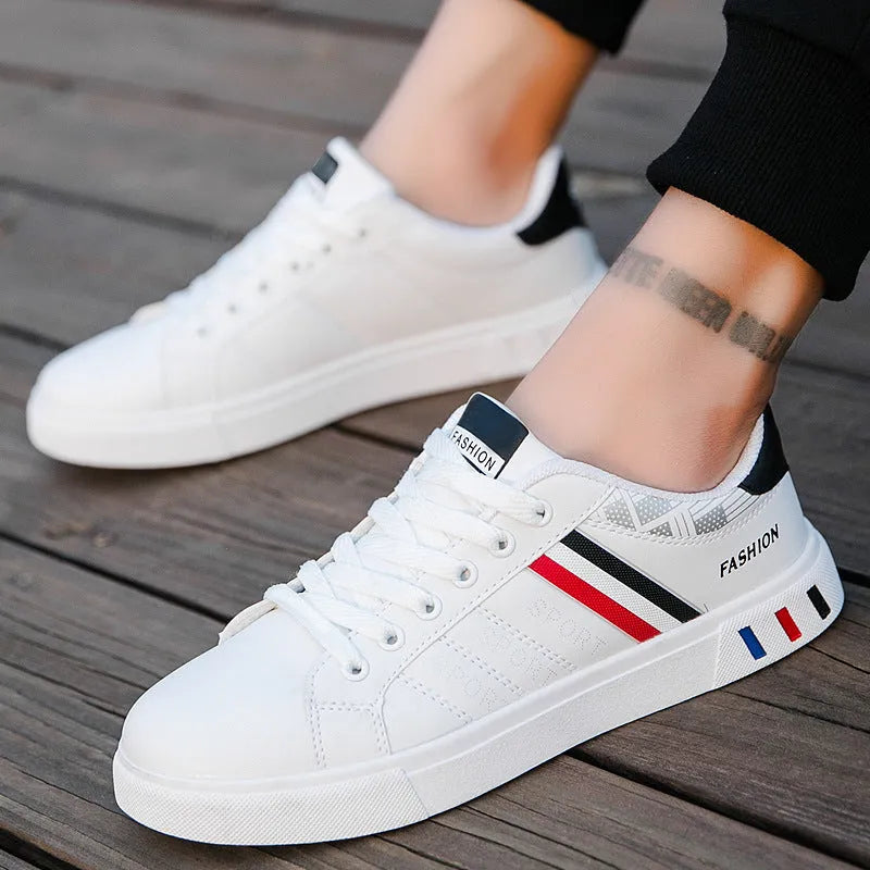 Men's black sports shoes on a white background, showing the classic trainer design and rubber sole.