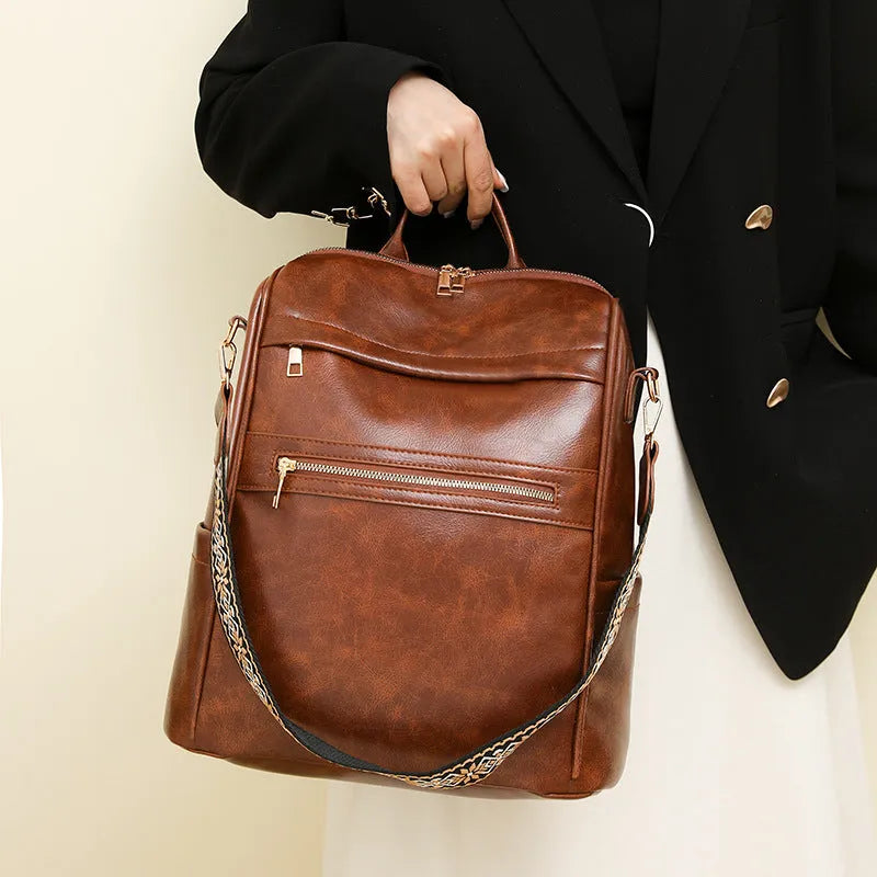 Retro PU backpack in black with multiple compartments, waterproof and wear-resistant, for daily use.