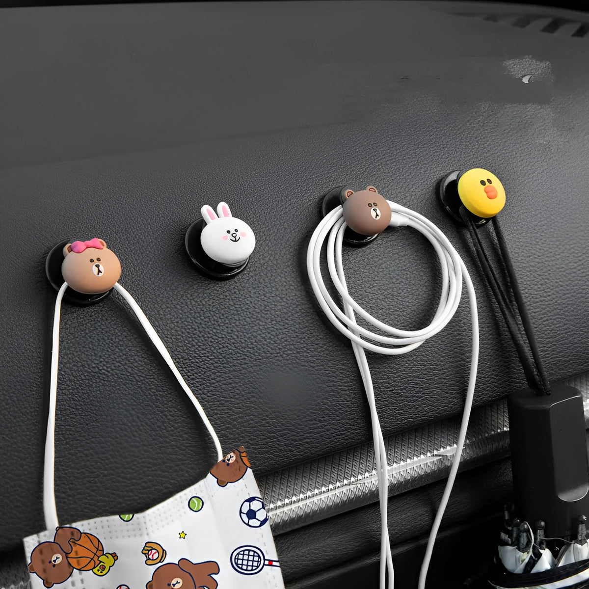 Small cartoon car interior hook with adhesive backing, PVC body and rounded silicone shape, shown in BROWN style.