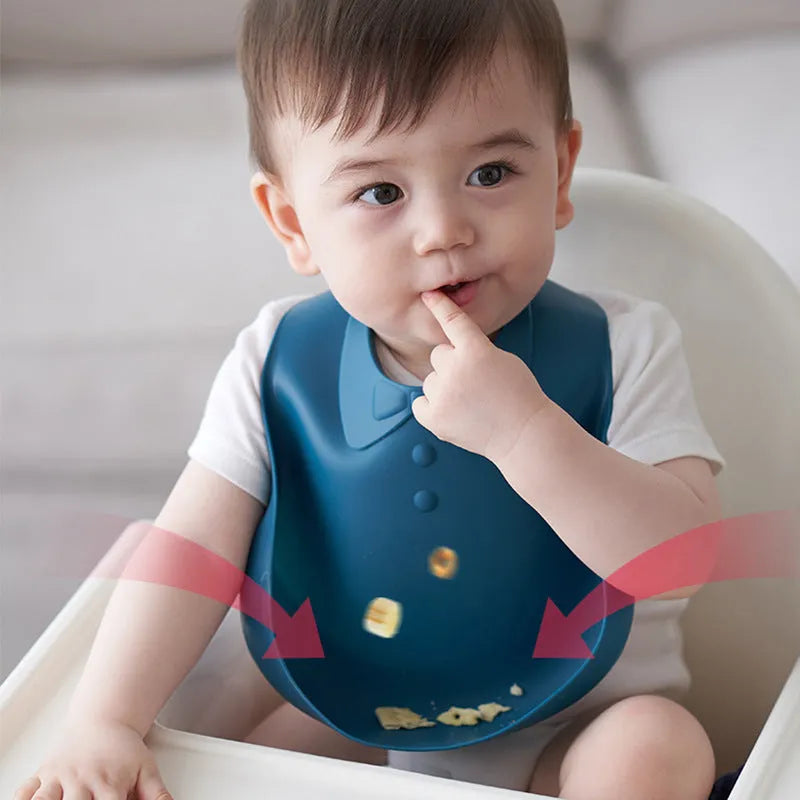 Waterproof soft plastic children bib with cartoon pattern in red, green, and blue colour options