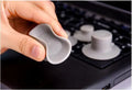 Grey laptop cooling stand with four silicone feet creating an air gap under a silver laptop.