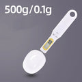 Black electronic measuring spoon scale with digital display showing weight measurement
