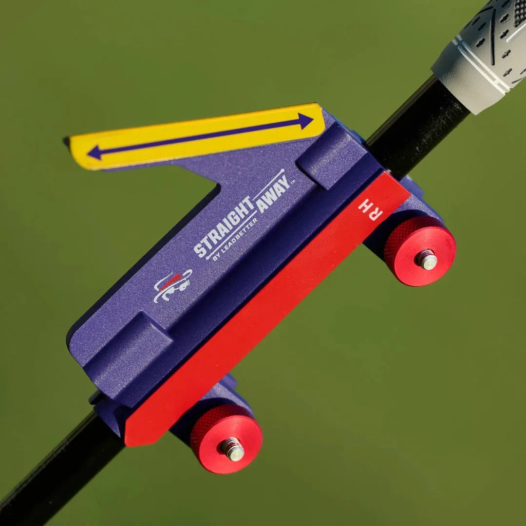 Golf swing plane simulator training aid made of plastic on a practice green.