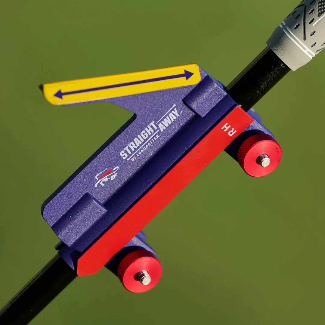 Golf swing plane simulator training aid made of plastic on a practice green.