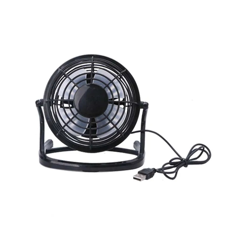 Compact black mini USB desk fan with adjustable tilt head on a wooden desk.