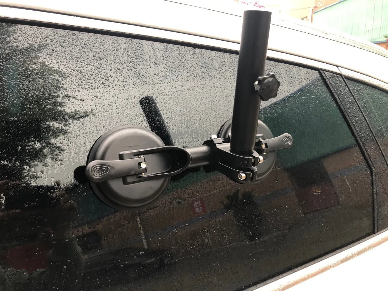 Black off-road car glass sucker base with round rubber disc for windscreen mounting.