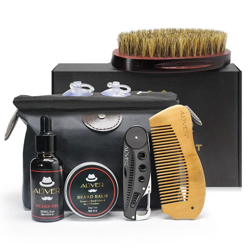 7-piece black beard grooming set with wood brush, metal comb, scissors, apron and cleaning brush on a surface
