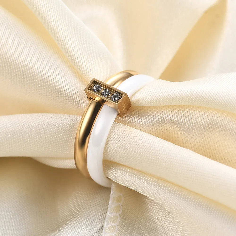 Steel black zirconium ceramic women's ring with 6mm wide band and glossy round inlay detail on a finger.