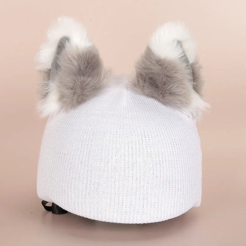 Colourful plush cartoon hat decoration sitting on top of a ski helmet