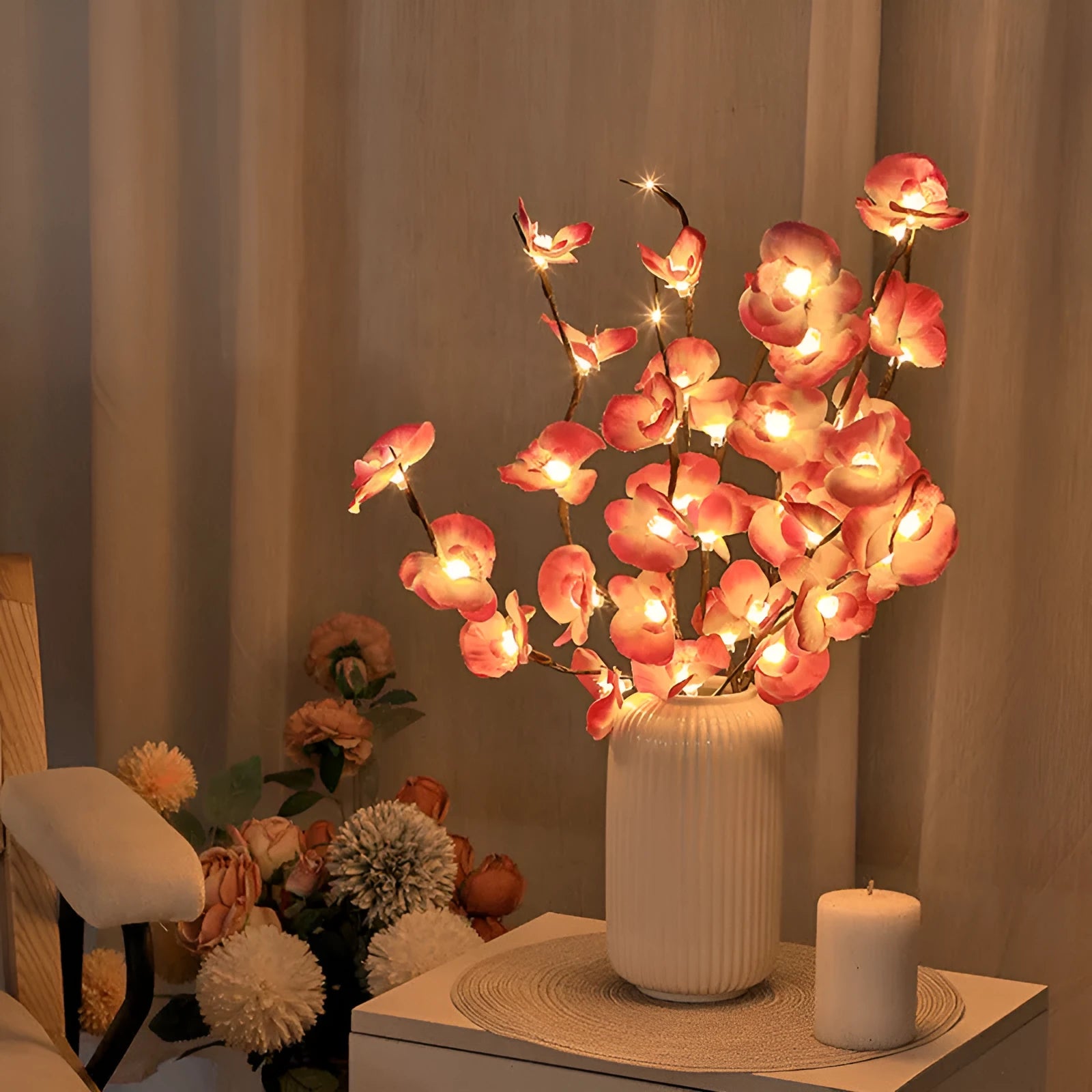 Pink LED phalaenopsis orchid branch decorative light, 65cm long, with warm white illumination on battery power.