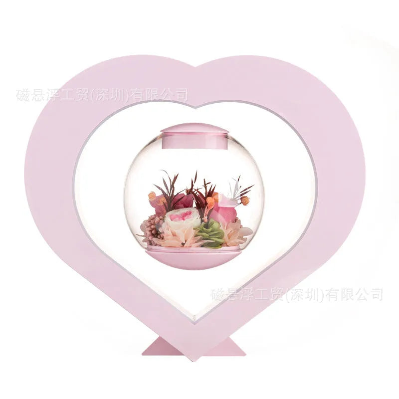 Pink preserved rose ornament with LED lights, shown with and without a decorative base.