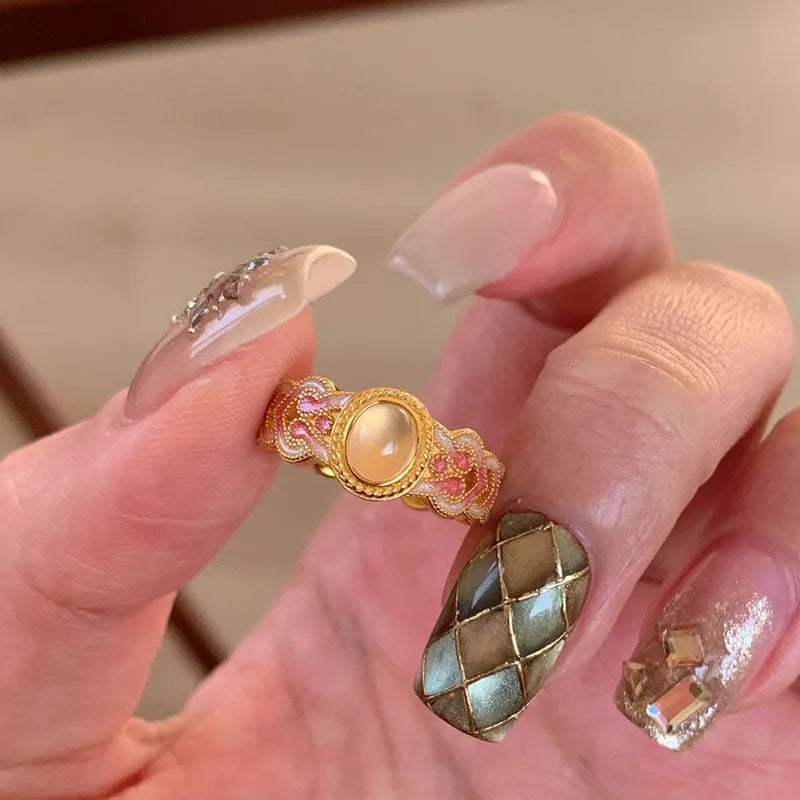 Geometric open ring with pink crystal enamel on gold-plated copper band.