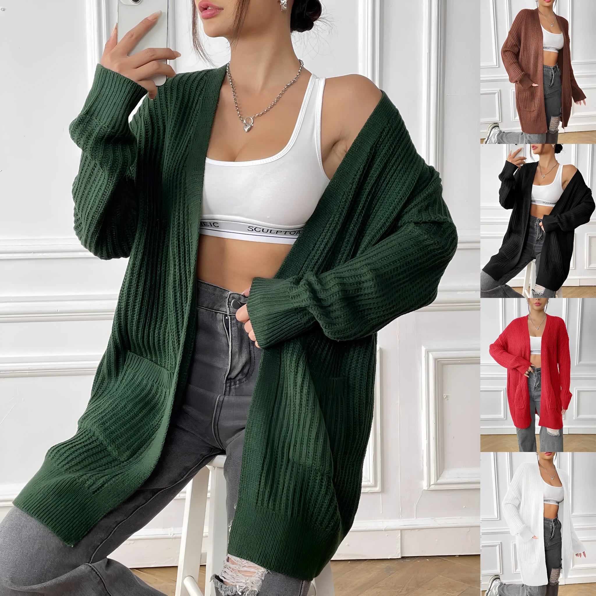 Women's dark green loose-fit acrylic knit cardigan with long sleeves on a hanger.