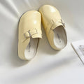 Flat buckle casual sneakers in yellow colour with round toe and PU upper material