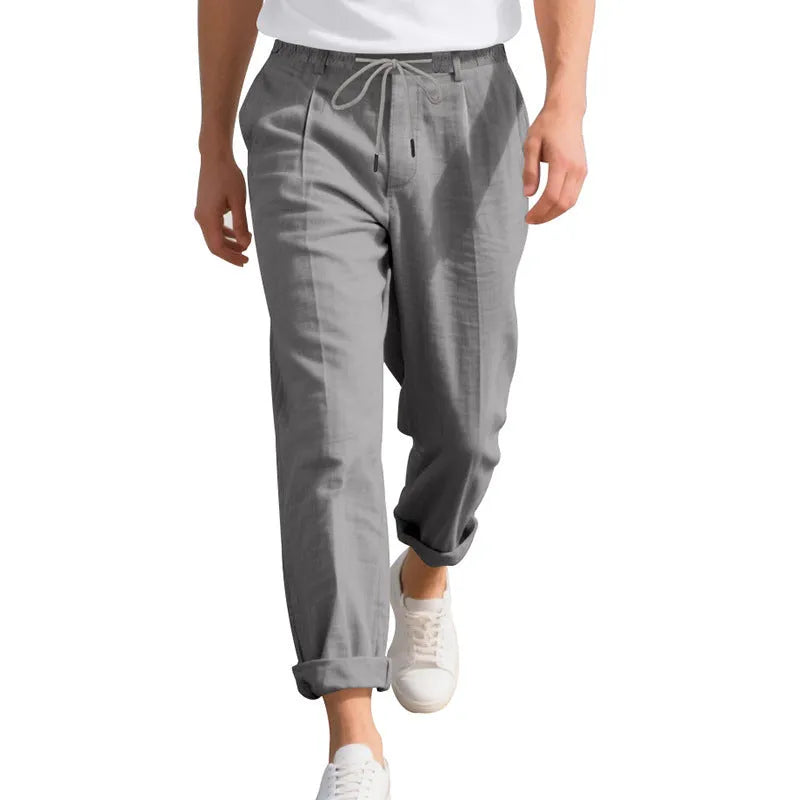 Men's straight-leg linen trousers in light khaki with a drawstring waistband.
