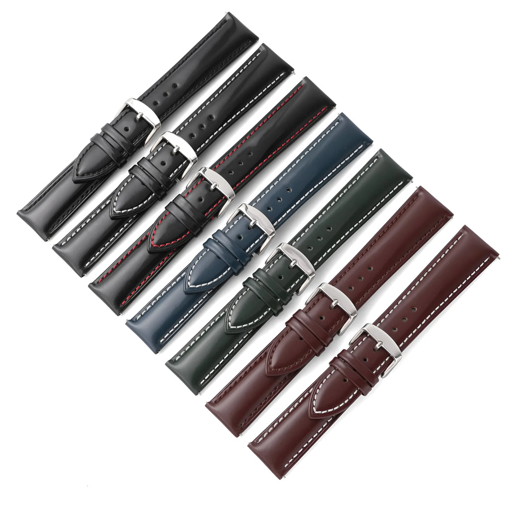 Quick release watch strap in black cowhide leather with white contrast stitching, shown detached from a watch.