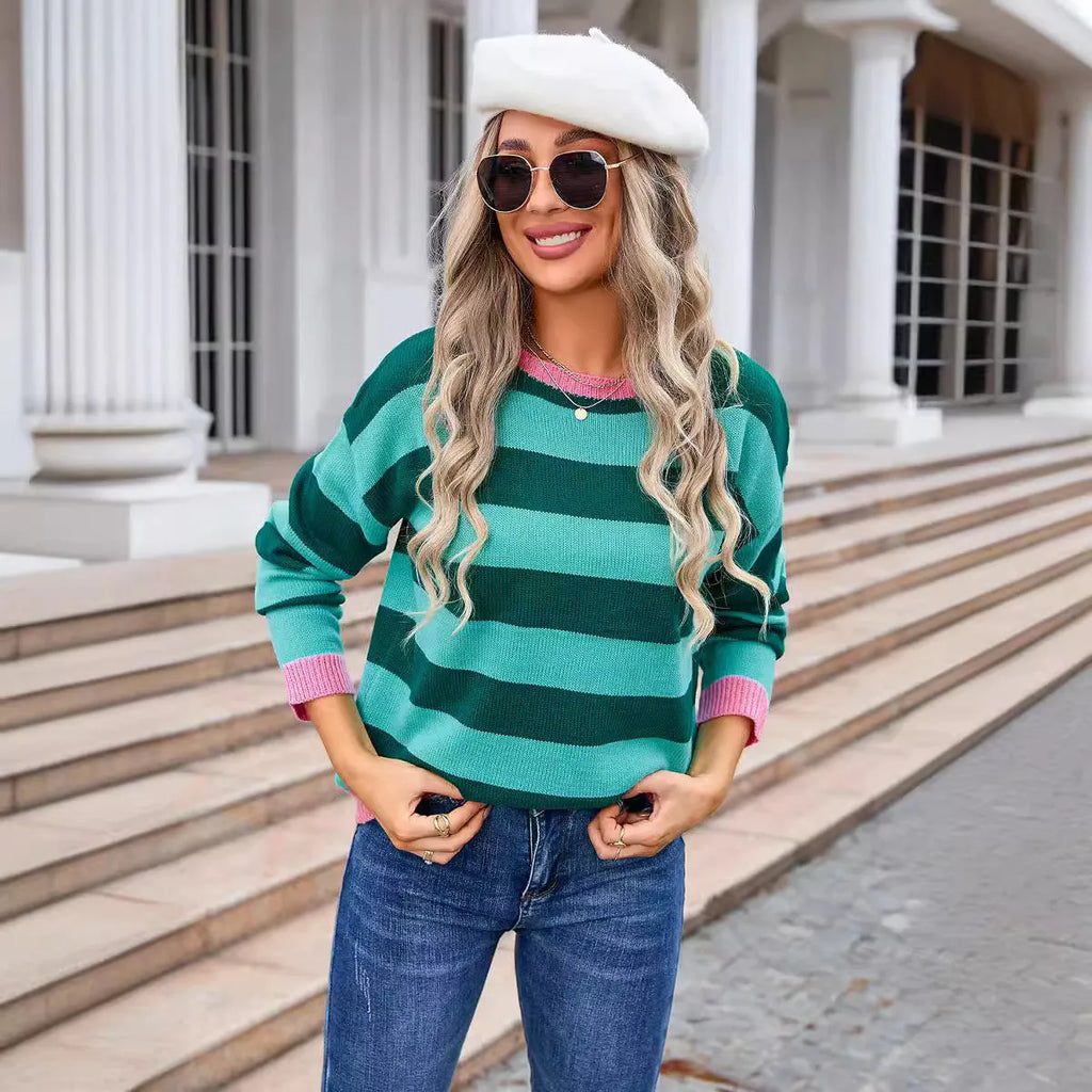 Women's loose fit long sleeve acrylic sweater in blue, showing round neck and regular sleeve.