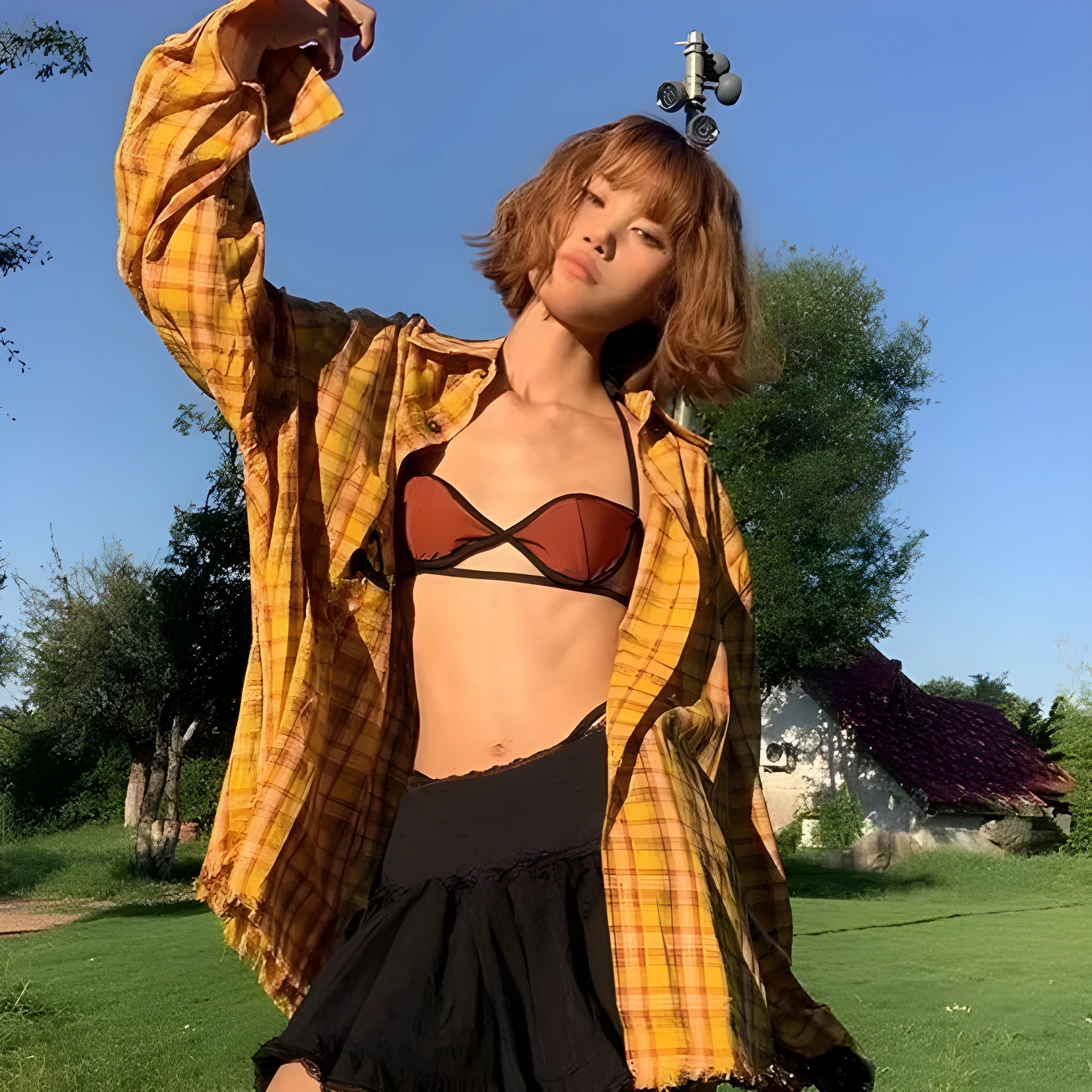 A loose-fit yellow plaid cardigan shirt for men and women, shown on a hanger.