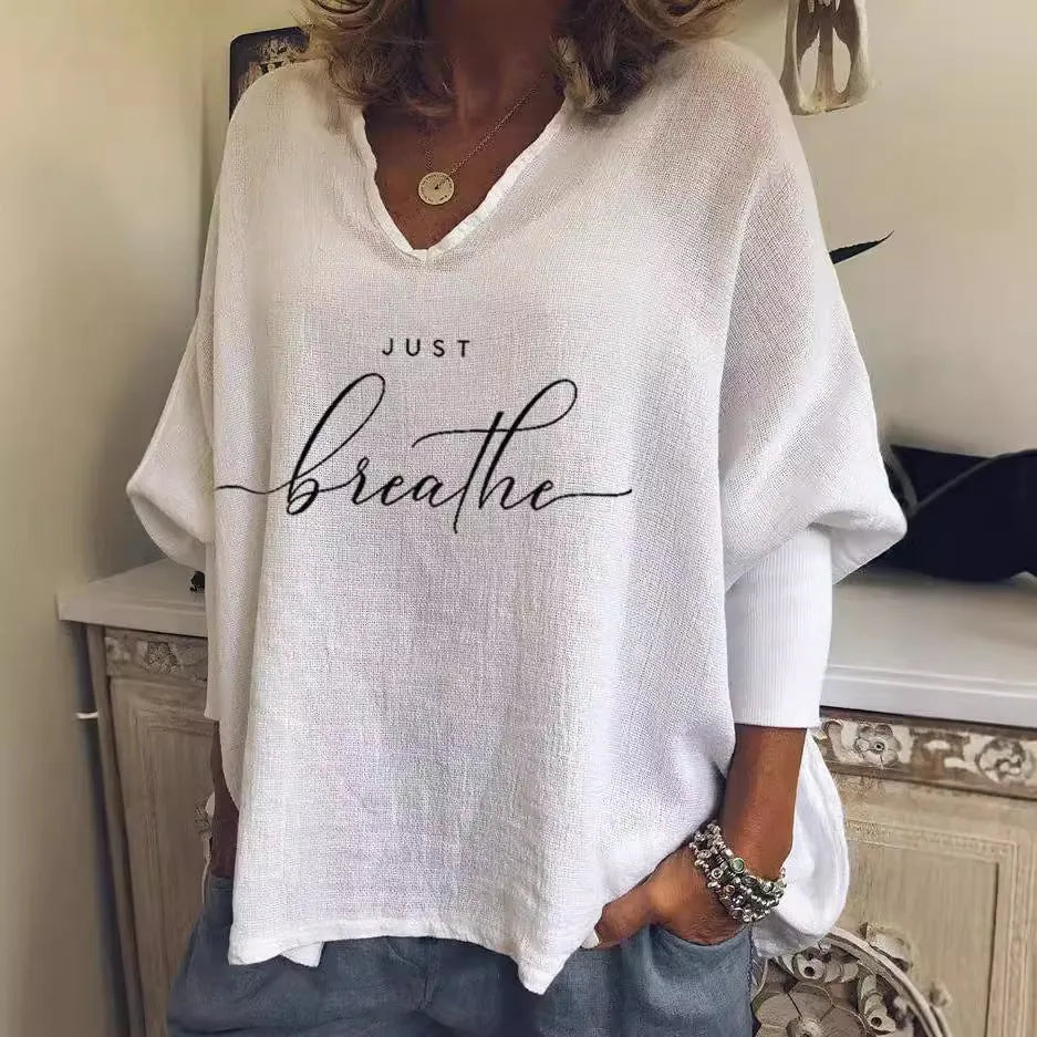 Woman wearing a loose V-neck long sleeve top in a digitally printed brushed silk fabric