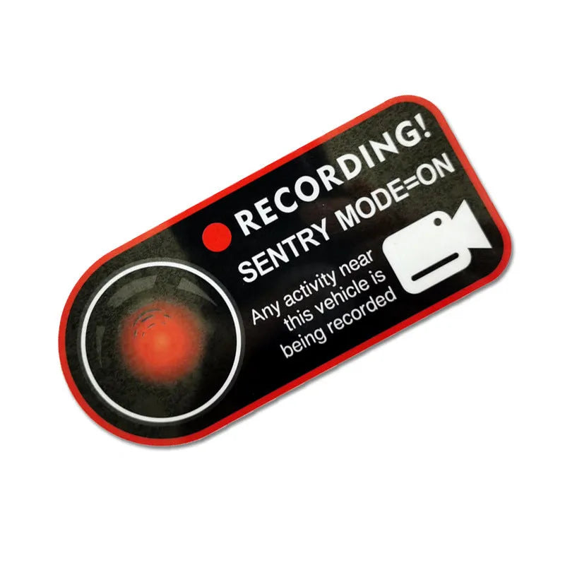 A pair of white rectangular Tesla Sentry Mode warning stickers with black text, measuring 11cm by 5cm.
