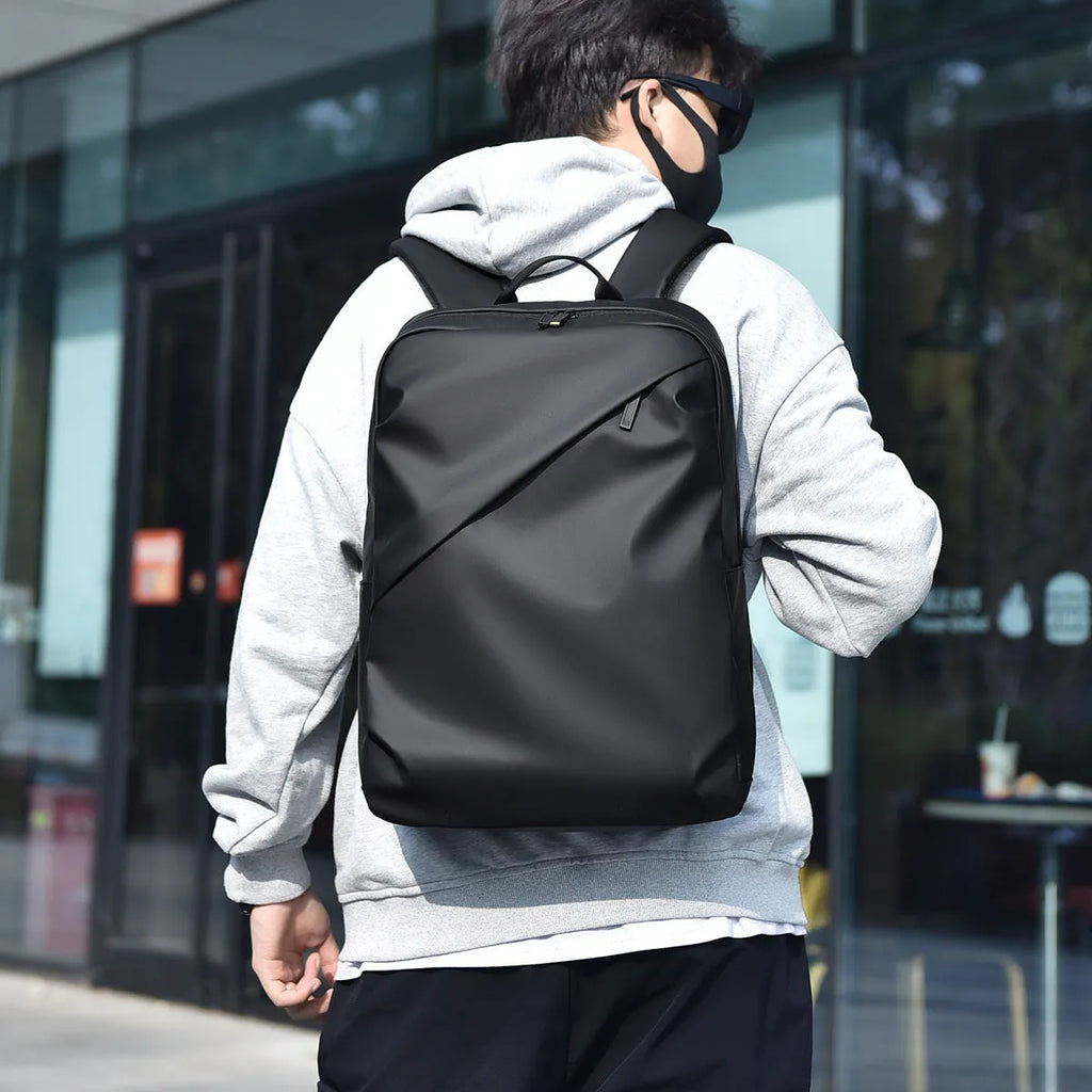 Waterproof PU leather laptop backpack in black, blue or grey with large capacity and laptop compartment