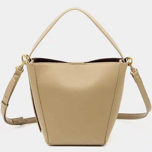 Urban minimalist bucket-style crossbody shoulder bag in PU with three-dimensional outer pocket, black colour option, flat lay view