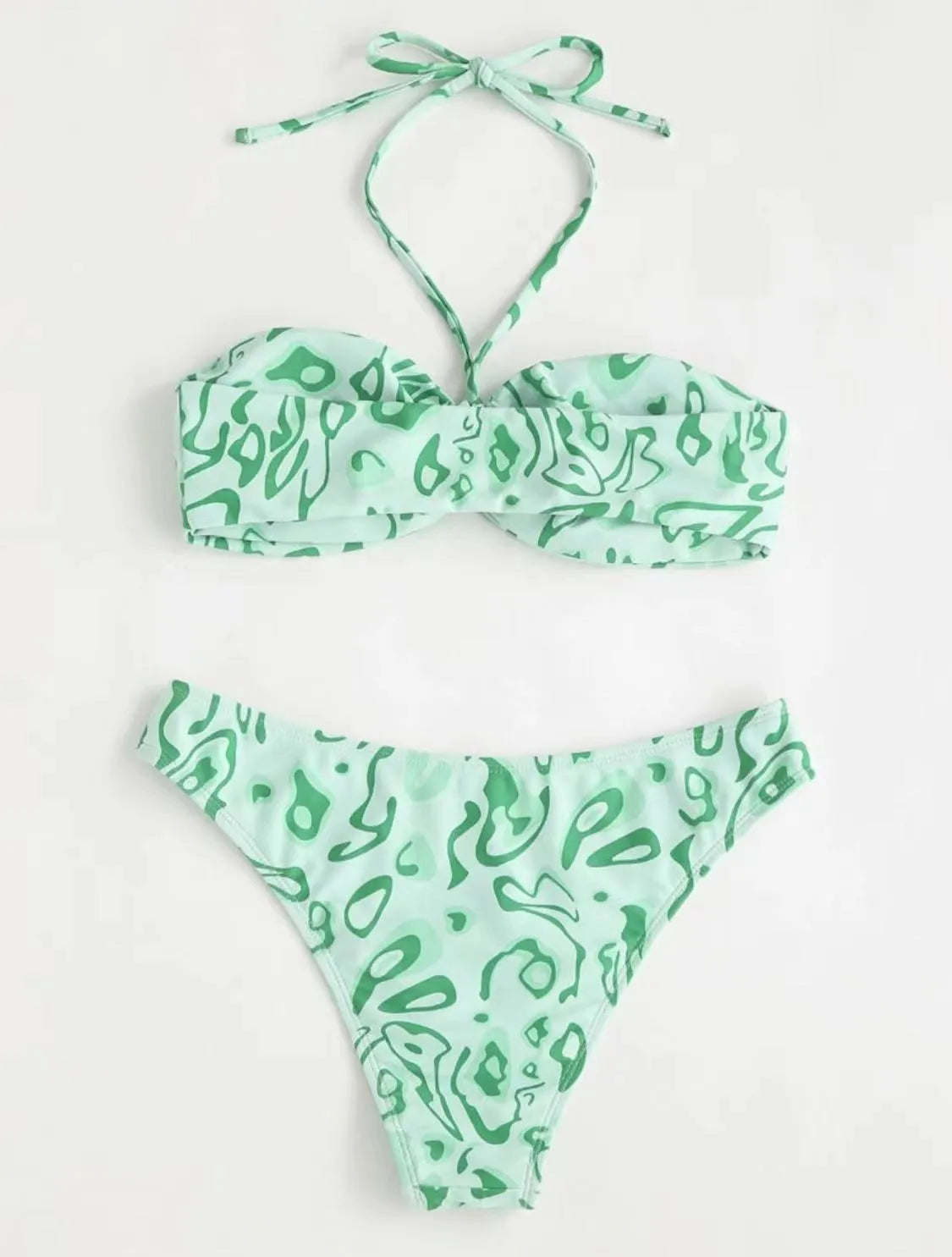 Green floral bandeau bikini swimsuit with split design and adjustable straps on mannequin