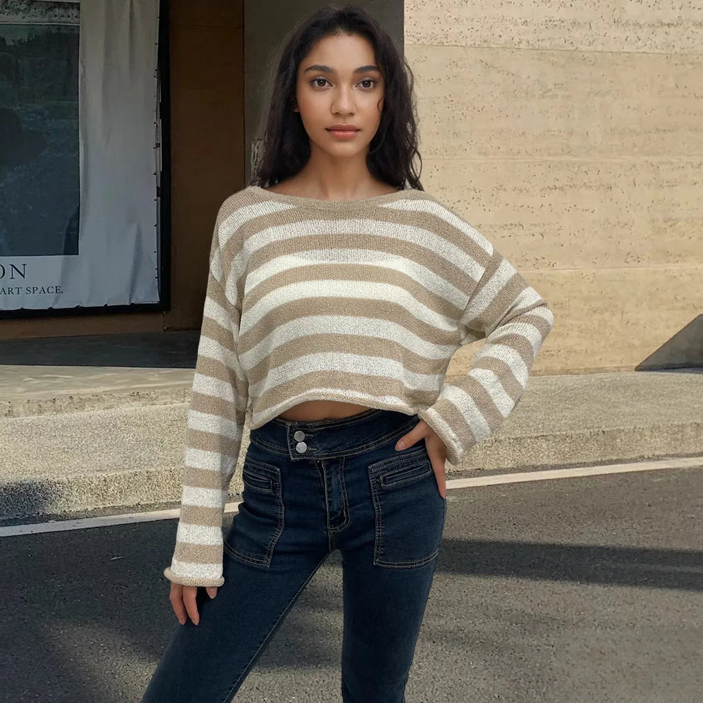 Woman wearing a striped long-sleeve sweater in mercerised cotton, showing front and back wearability with exposed navel detail.