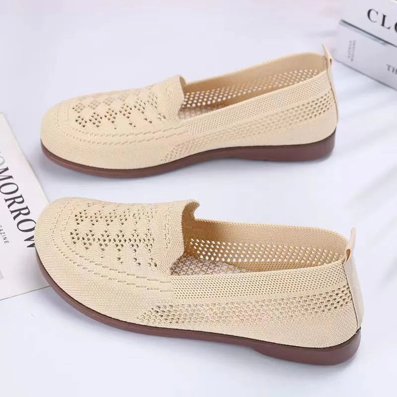 Beige casual tennis shoes for women with mesh upper and antiskid sole on a plain background.
