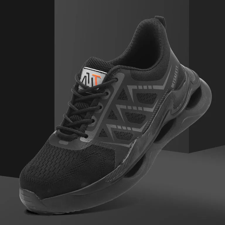 Black steel toe cap safety shoes with flat knitted uppers and rubber soles on a work surface