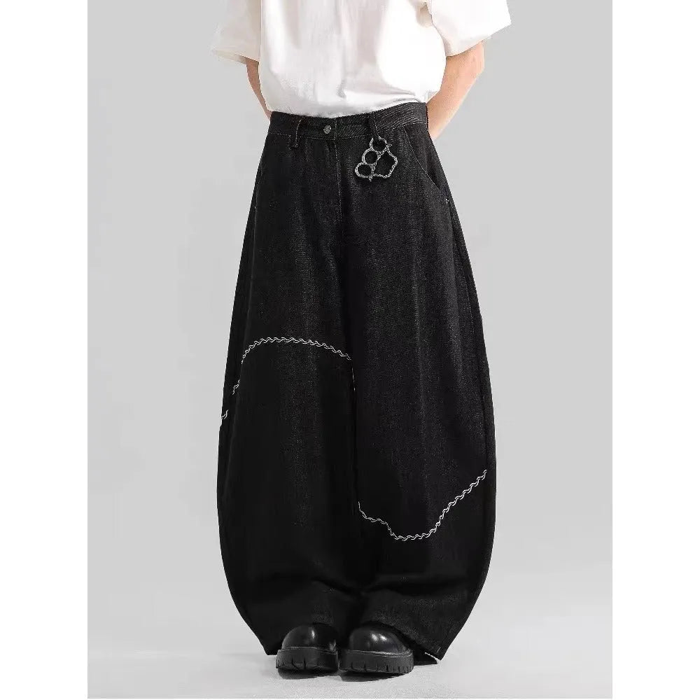 Black straight-leg denim trousers with a mid-waist fit and micro-elastic waistband on a hanger.