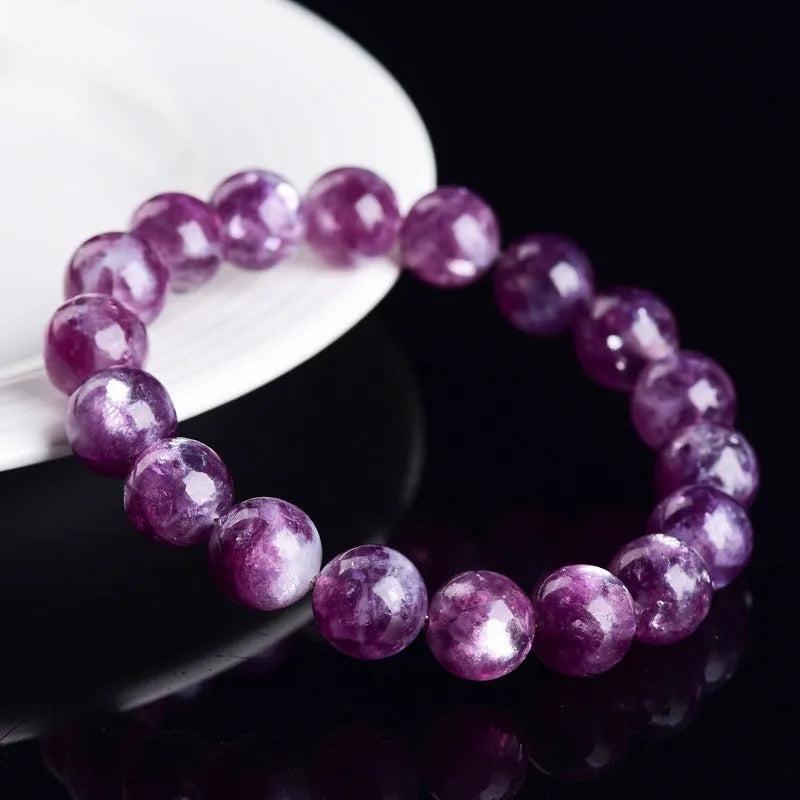 Polished purple and pink crystal grandmother bracelet with geometric beads on a wrist, showing Korean-style unisex design.