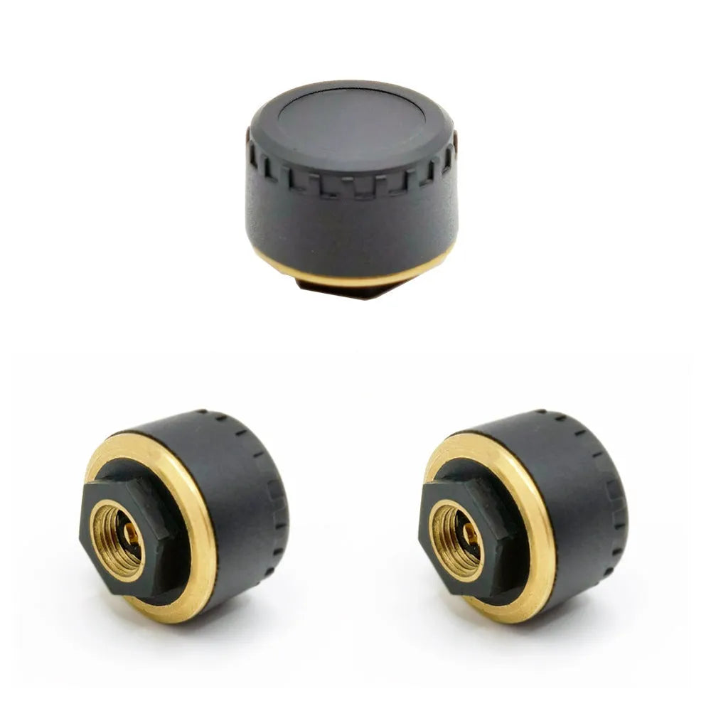 Four black Bluetooth tyre pressure sensors for car wheel monitoring via mobile phone app