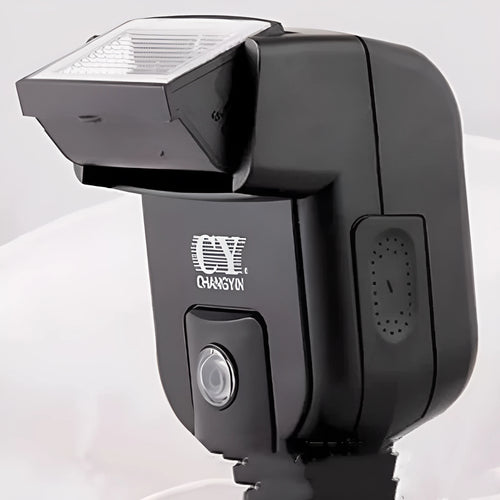 Compact black external camera flashgun with a tilted flash head, shown mounted on an SLR camera hot shoe.
