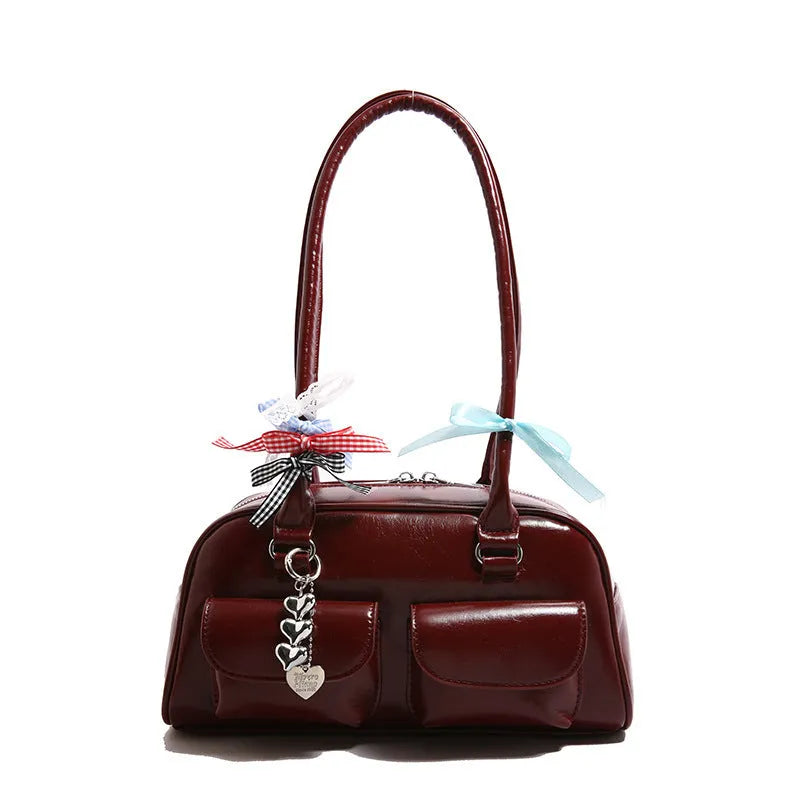 Brown retro pillow-shaped women's handbag with a flap closure and double shoulder straps.