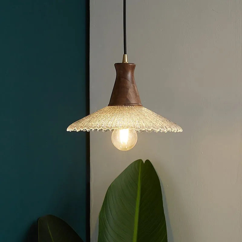 Brass-toned wood and glass chandelier with a retro design for ceiling mounting.
