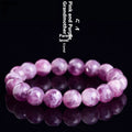 Polished purple and pink crystal grandmother bracelet with geometric beads on a wrist, showing Korean-style unisex design.