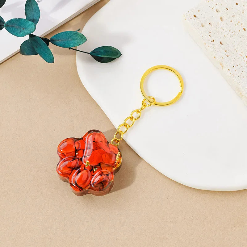 Small natural crystal cat's paw pendant on a metal keyring, available in various stone colours.