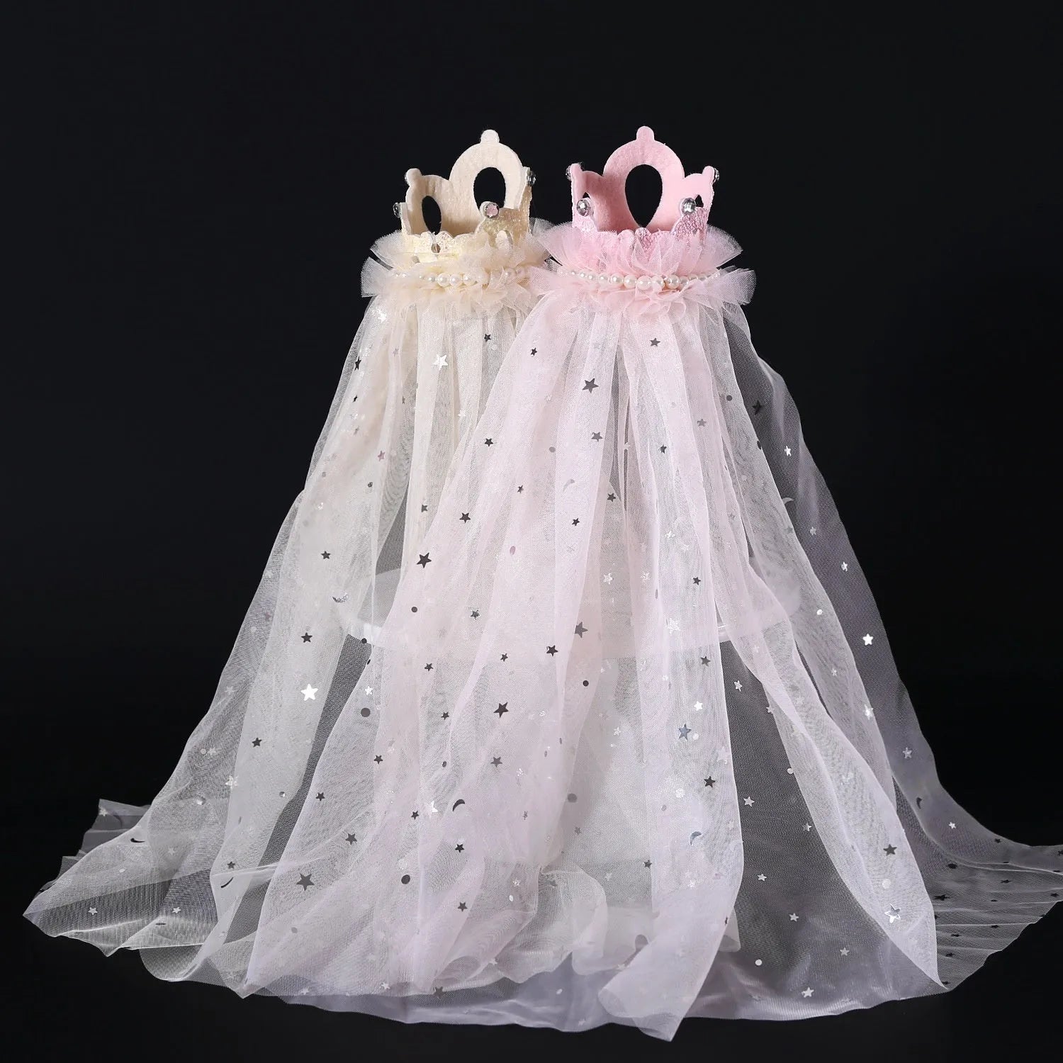 Pet cat wearing a white princess crown headdress with a beige veil accessory.