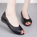 Women's black casual peep toe sandals with an ankle buckle and rubber mid heel.