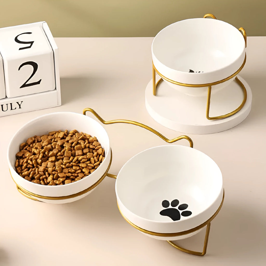 White ceramic pet bowl with iron frame featuring cat ear design, decorated with cat footprints pattern