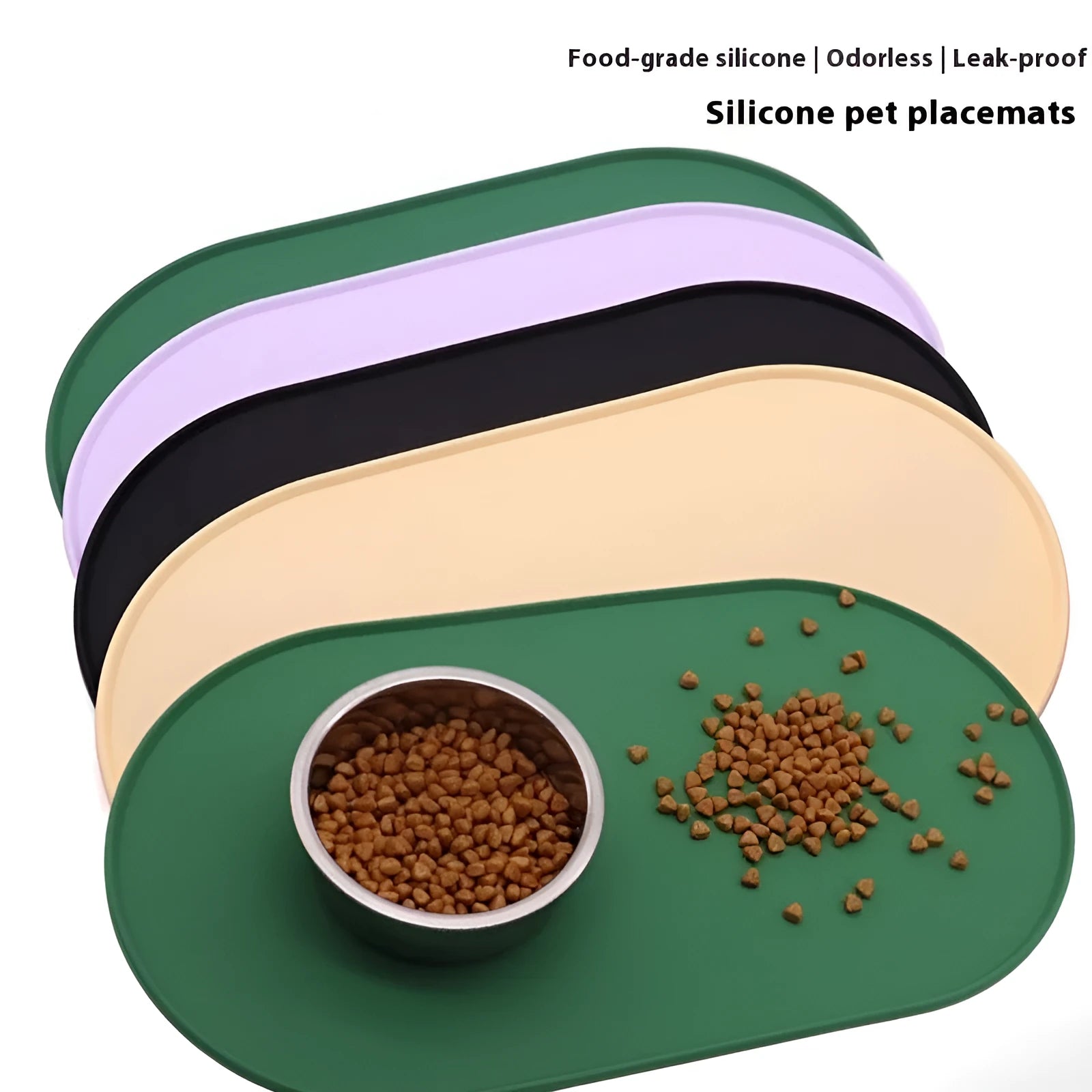 Green silicone cat feeding mat with raised edge containing a food bowl and scattered kibble on a kitchen floor.