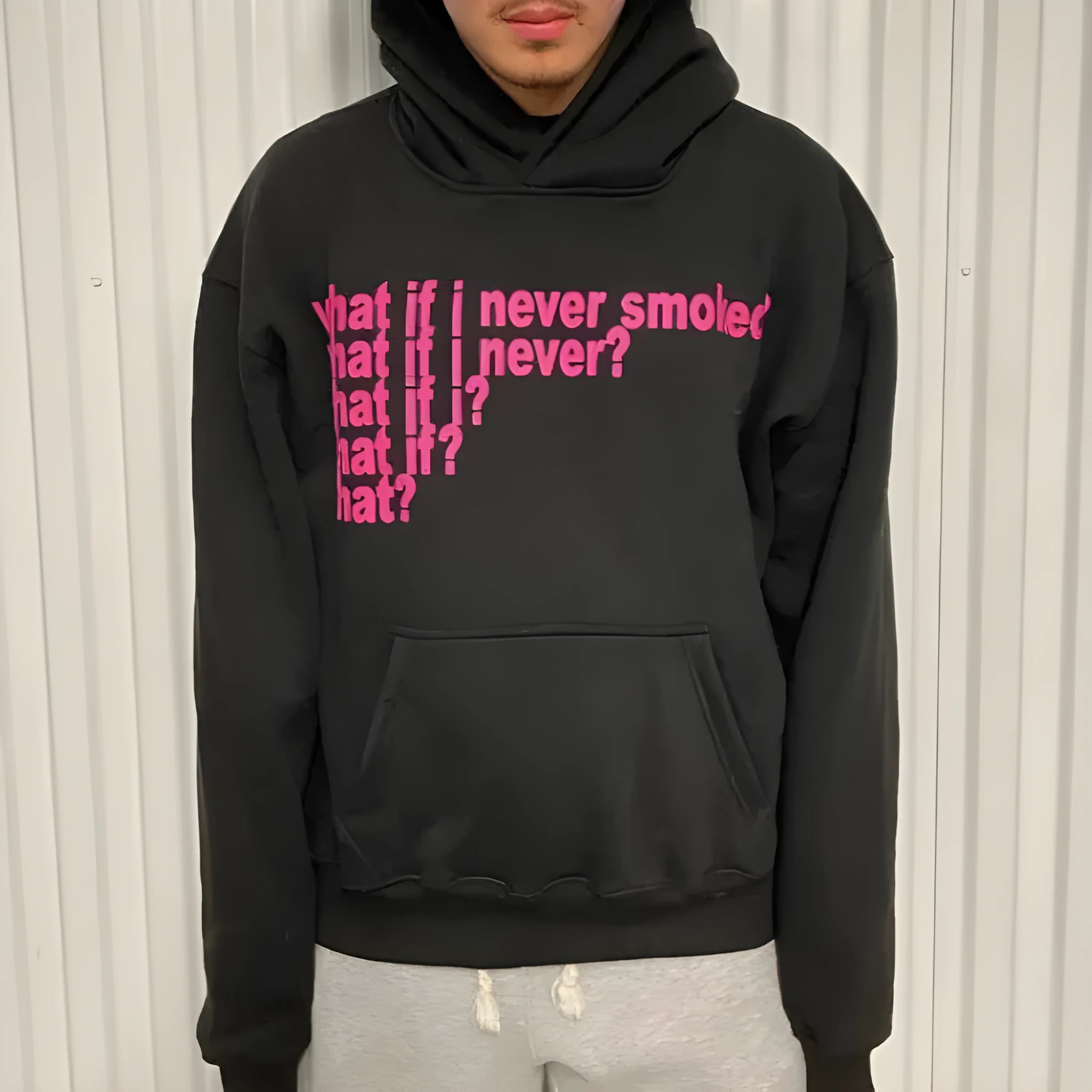 Black hooded pullover sweatshirt with white letter print pattern on the front.