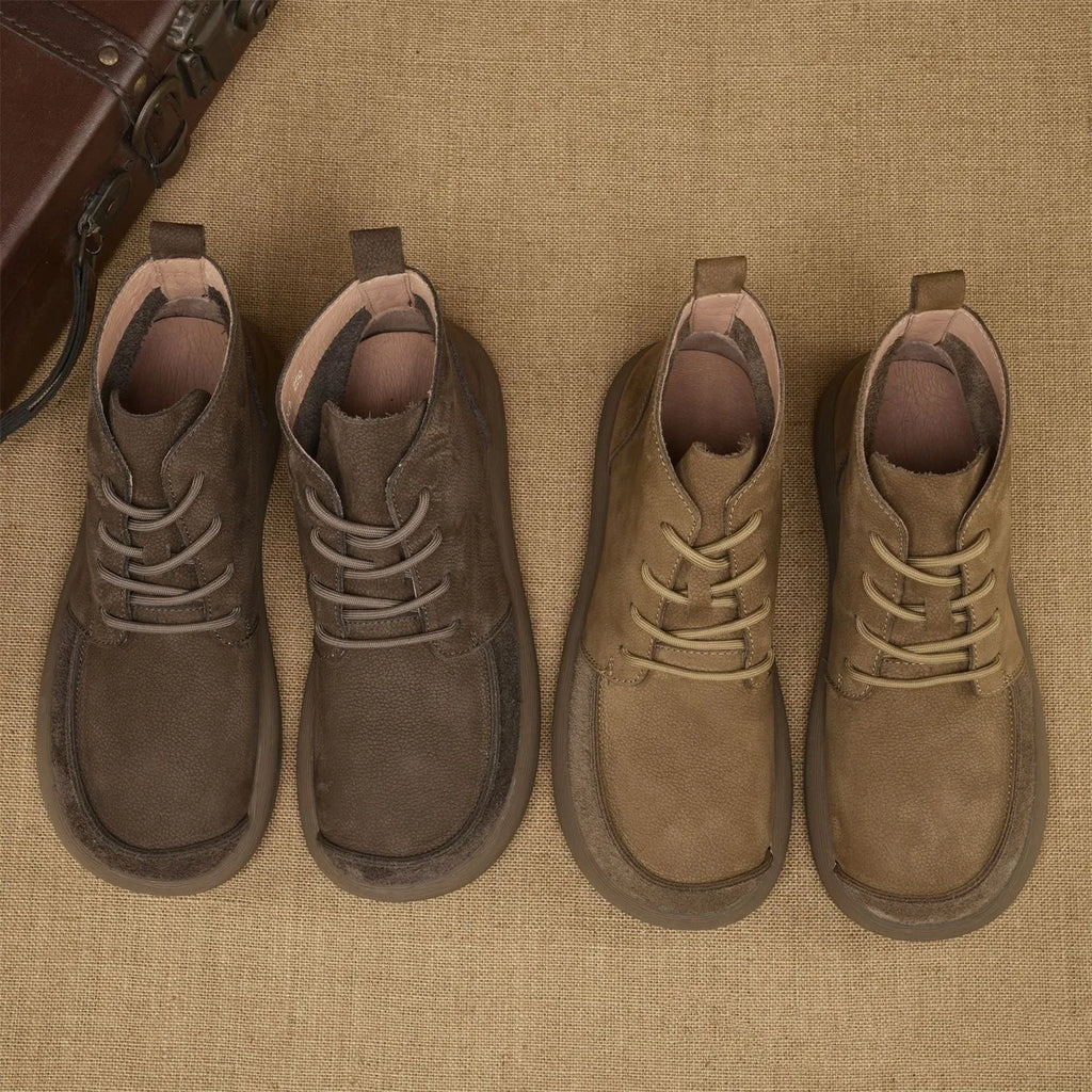 Men's grey genuine leather Martin boots with lace-up front and wedge heel on a textured background.