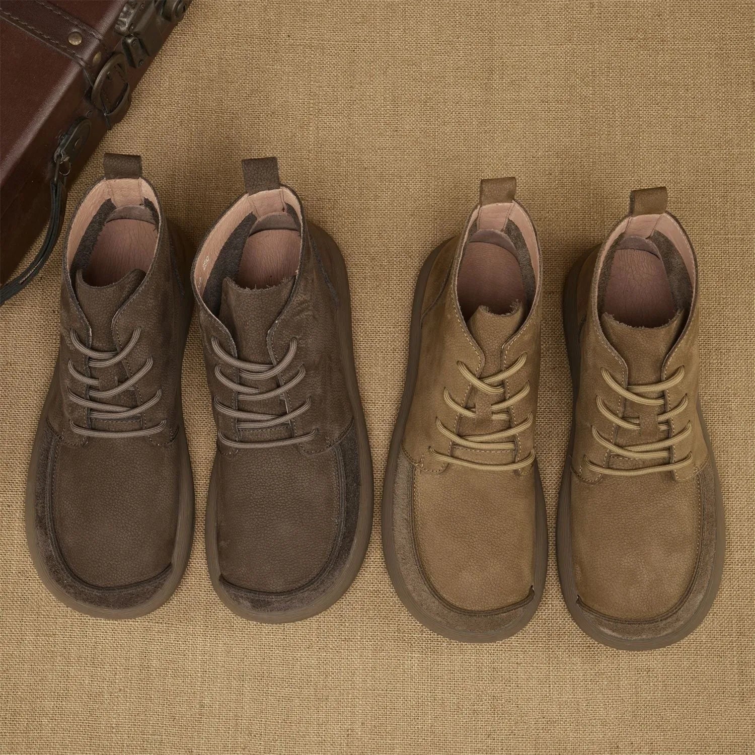 Men's grey genuine leather Martin boots with lace-up front and wedge heel on a textured background.
