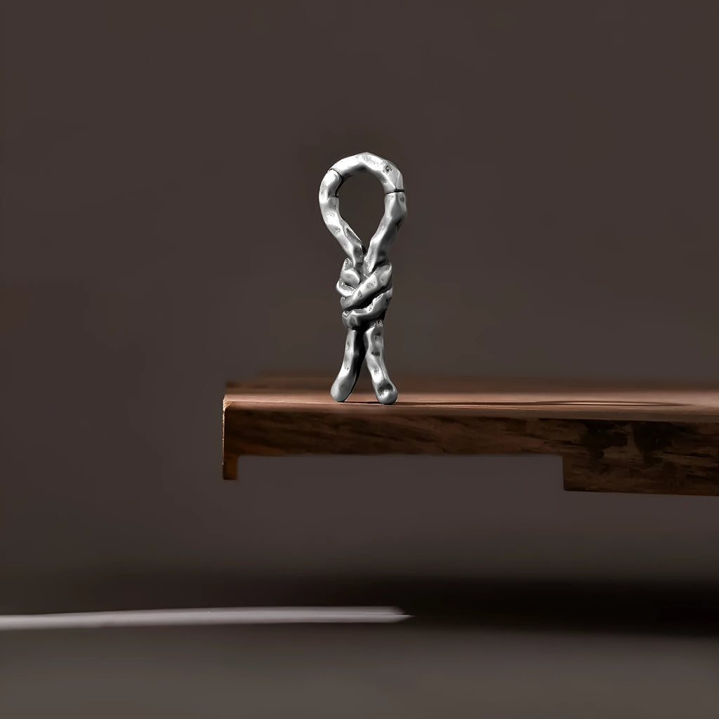 Close-up of Creative Bends And Hitches copper cartilage earrings with a 4mm gauge and retro bending design.