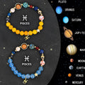 Two natural stone beaded bracelets with zodiac charms on a table, showing adjustable elastic cord.