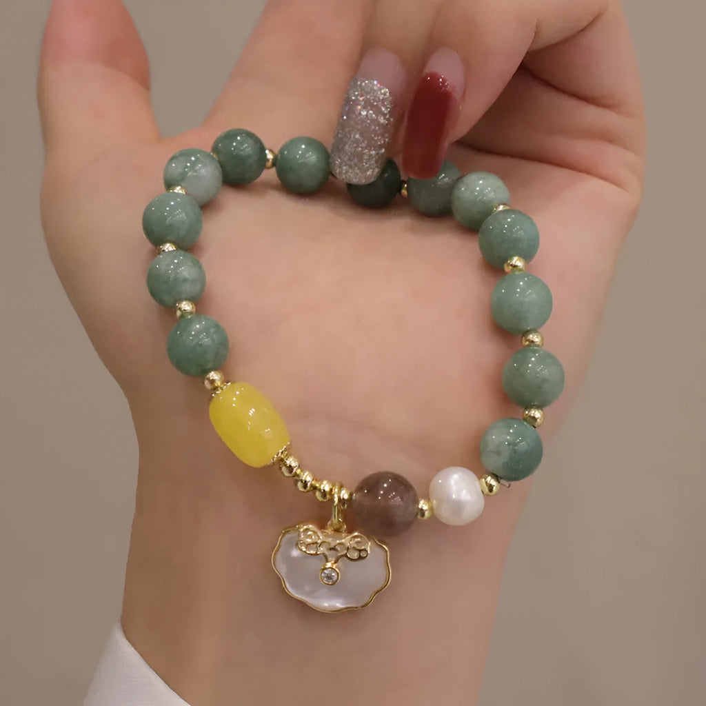 Women's green jade shell bead bracelet showing natural gemstone colour tones