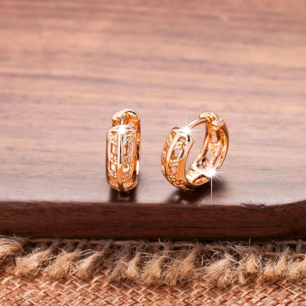 Rose gold plated copper earrings with hollow heart and leaf shapes, shown from front, approx 2.5cm tall.
